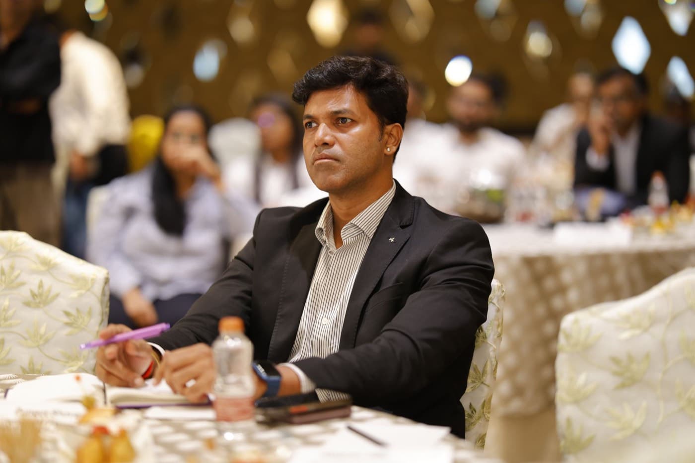Mumbai · a senior insurance leader listening in